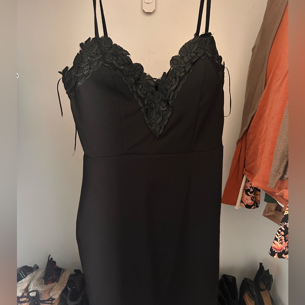 Tight fitting black dress.